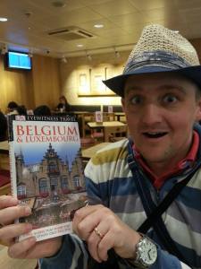 George at St Pancras station with a guide to Brussels